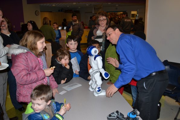 Mike Ogilvy of e-Stem Solutions tries to get his little robot buddy to dance.