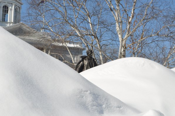1. Here we see one of New Hampshire’s celebrated statuefied figures, climbing from the depths of the mounting snow pile to conquer the mountain and claim his rightful throne as king of the bronzy snow guys (next photo). Frankly, we’re not surprised he was able to pierce the snow with his stony self.