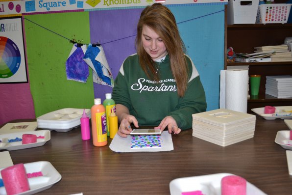 Jenna, daughter of owner Anita Wolcott, does a little showing off when making her colorful frame.