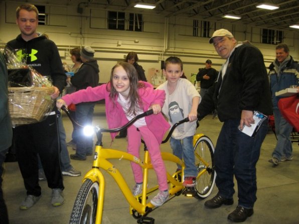 Among the items up for auction? This sweet banana-yellow tandem bike, proudly repped by winners Aaron and Shoelyn Hargraves, students of Concord Christian Academy.