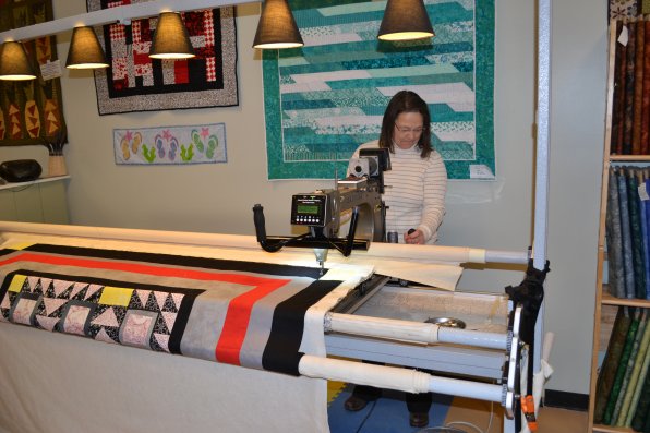 Betty Desmarais, owner of Lizzy Stitch, is a pro at quilting without actually looking at the quilt, thanks to her long arm machine.
