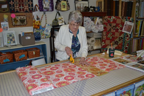 Nancy Gesen, owner of the Golden Gese, has plenty of experience cutting fabric after almost 29 years in business.