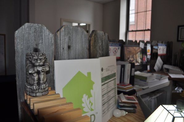 Paul Leveille’s desk at Resilient Buildings Group features a fence he repurposed from his sister-in-law. And an awesome gargoyle.