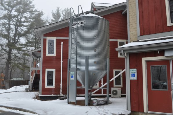 <strong>N.H. Audubon's McLane Center</strong></p><p>The facility is heated by wood chips, stored in an outdoor silo (photo below right). And that’s not all – wastewater from the sinks and a dishwasher in the basement are combined with gray water from the restrooms and are pumped outside to a wildflower garden. The elevators are lubricated with canola oil instead of petroleum-based oil, and some of the insulation was made from recycled newsprint. So there could be Insiders in those walls! The building is designed to use 90 percent less water than a traditional building.