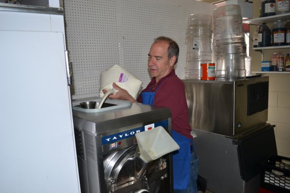 Arnold adds the 15 percent butter fat ice cream mix to his 1983 ice cream maker.