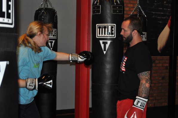 Courtney Eschbach-Wells delivers a body blow to the heavy bag under the watchful eye of trainer Paul Gaffney.