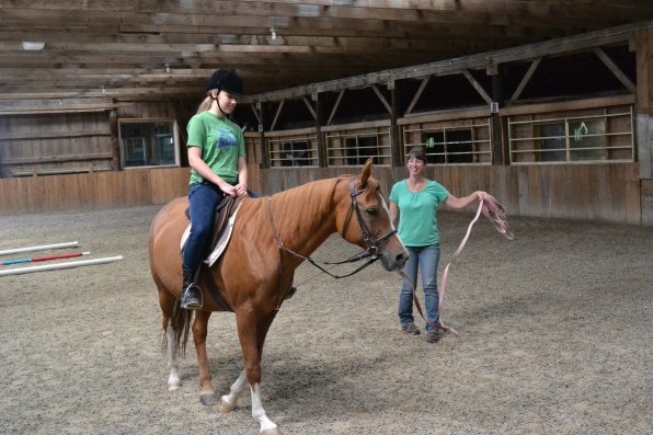 Emma Dusavitch of Concord takes Eta for a spin under the watchful eye of barn manager Linda Smith.