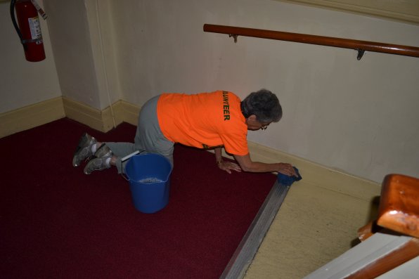 Judy Eliasberg isn’t afraid of getting down to ground level to make sure all the dirt is gone.