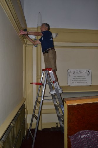 Fred LaFontaine was a dusting machine atop his ladder.