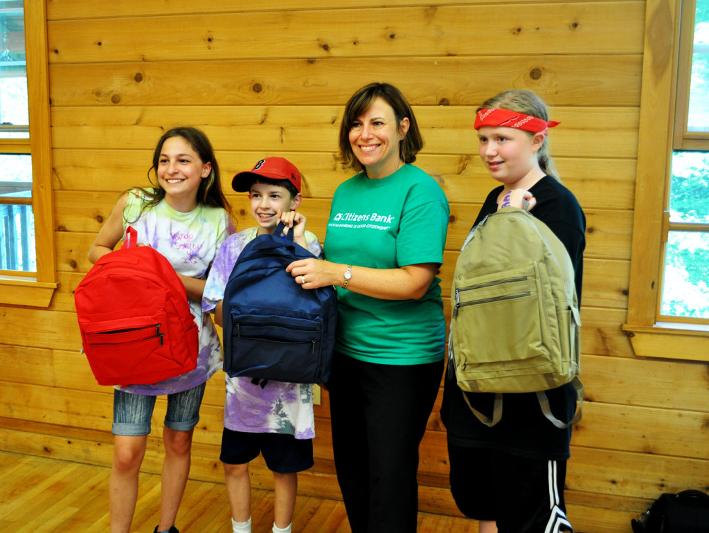 Citizens Bank doled out 100 backpacks filled with donated school supplies to kids at Camp Spaulding in Penacook and the Friends Program in Concord as part of the Gear for Grades program. The Camp Spaulding presentation was part of Friday’s camp wrap-up ceremonies. Pictured: Kyra and Matthew Franklin (left) and BreeElle Shoop display their new backpacks alongside Kathleen Reardon of Citizens Bank.