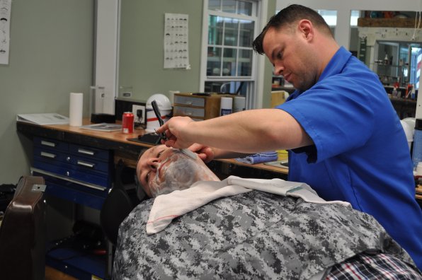 Barber student Nate Riggs gives fellow student Mike Davies a close shave. Trusting soul, that Davies.