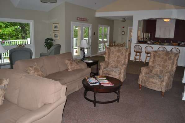 The common area featuring comfy couches and a small kitchen area for families to use.