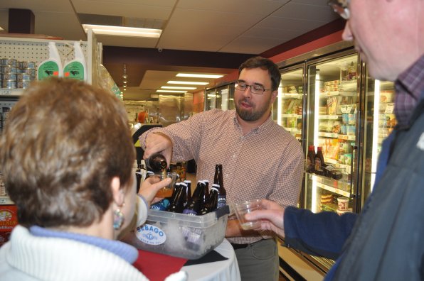Joe Moran of Sebago Brewing Company pours a sample for Kathy Harvey.