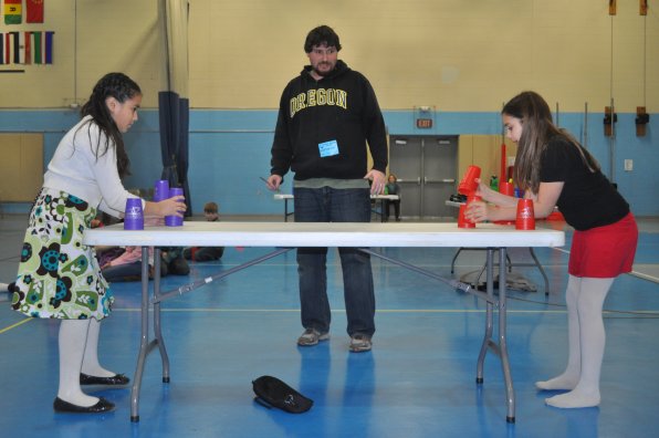 Tim plays the role of judge in a speed stacking battle.