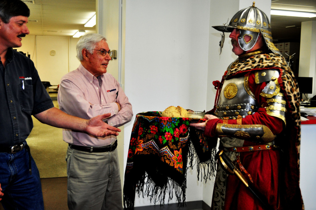 The New Hampshire Humanities Council considers Evans Printing a knight in shining armor for its printing efforts. So how better to thank the staff than by bringing a real knight in shining armor? Eryk Jadaszewski surprised the Evans staff in his homemade armor last Tuesday, delivering trays full of baked goods. Above, Robert (left) and John Holman accept the gifts.