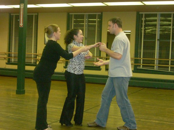 Kaleena Guzman (center) and her partner Steve Besette get a few tips from dance instructor Jen Hamilton.