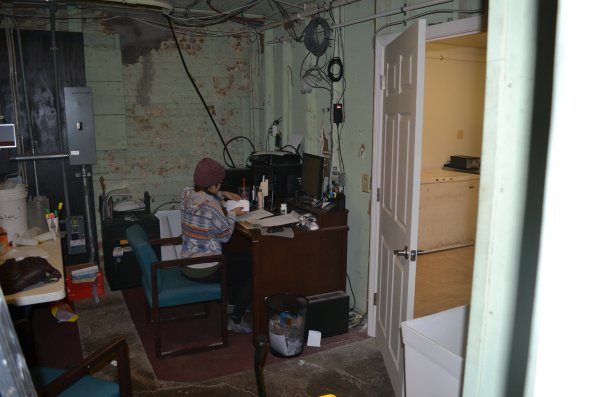 Kina Gilson does some bookkeeping in what some may call Dos’s dungeon office, while the shiny new kitchen area is essentially mocking her right outside.