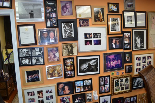 Vinx’s wall of fame, featuring pictures of himself with cool people and in cool places.