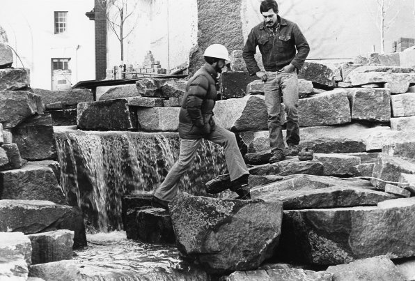 Then-city engineer E. Douglas Barnard and Marc Chronis walk near the fountain, which Chronis built.