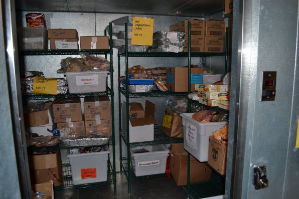 The walk-in refrigerator is filled with all kinds of donated food.