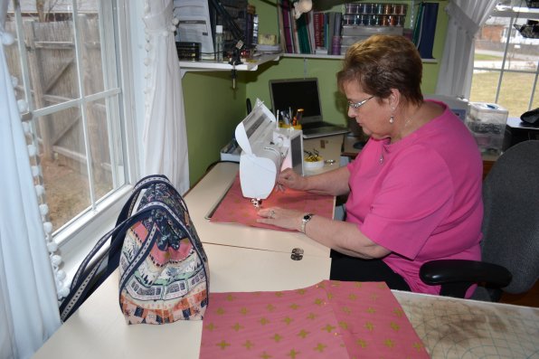 That’s Sharon Cuddemi just slaving away at her sewing machine, making another one of her Gooney Bags that could be yours.