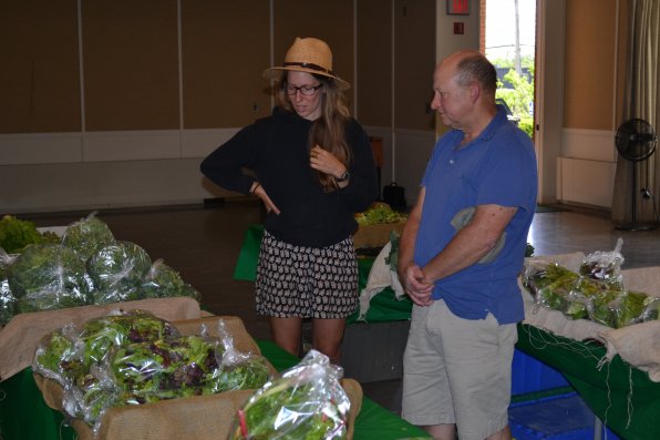 Ken Stuart gets a run down of what Local Harvest is all about from CSA whiz Sarah Hansen.