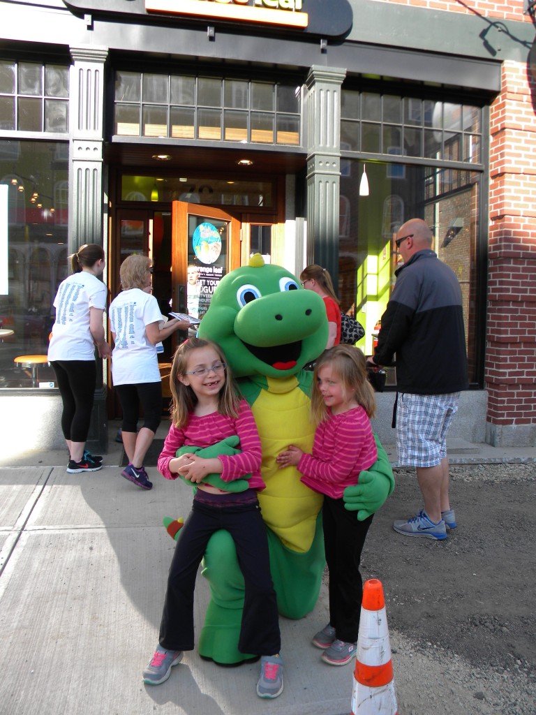 Super cute kids wearing identical shirts alert! Leah and Sarah Burke of Bedford get hugs from Lil’ Iguana outside Orange Leaf Frozen Yogurt before last Thursday’s Rock n’ Race in Concord. Based in Nashua, Lil’ Iguana’s Children’s Safety Foundation is a non-profit organization that uses prevention programs to keep children safe from abduction, sexual abuse, child predators and serious accidental injuries in an effort to have children retain vital safety messages (Photo by CURTIS FRASER / For the Insider).