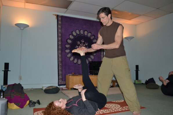 Yoga Center owner Jim Readey helps Moira Brouillard of Canterbury with her quest to become a human pretzel.