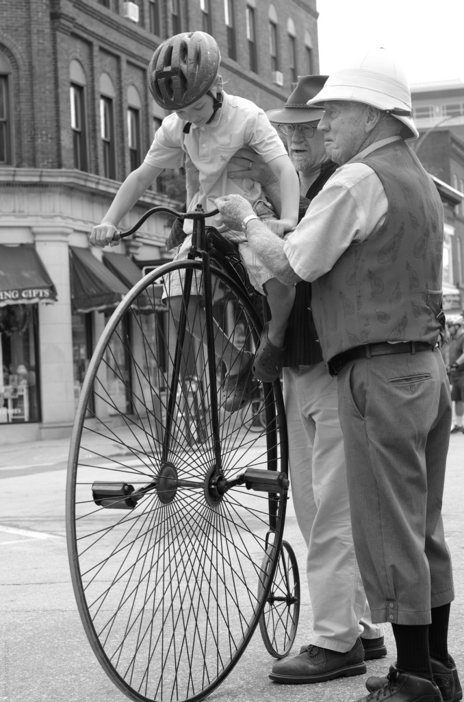 With assistance from two enthusiastic veterens of the bicycling sport, a young boy sits atop a penny farthing, to experience first hand the thrill of riding high in the saddle.  The Main Street event was a recreation of a 1890 photograph in Concord, as a part of the city's 250 year celebration next year.</p><p>Photo courtesy of Larry Levinson.
