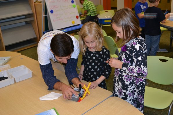 Instructor John Hall helps Reese and Ava Philbrook perfect their windmill that pushed a tissue so fast that it put a hole in the wall of the classroom the program was held in (note: possible exaggeration).