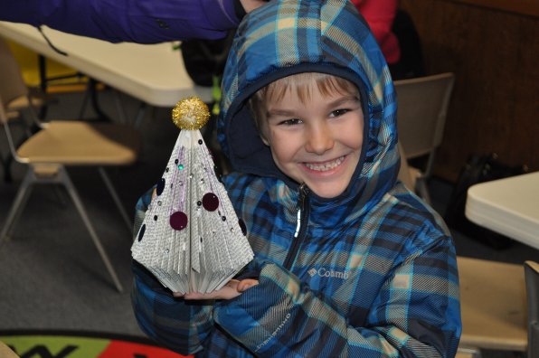 Colin Fortier, 7, proudly displays his colorfully decorated tree, complete with a sweet golden ball on top. Is that a nod to the State House, perhaps?