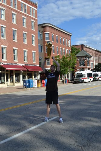 Downtown traffic knows to stop when Matt Bonner carries the trophy into Main Street.