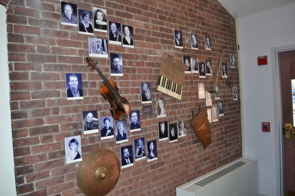 A wall of fame of sorts, featuring fancy music-type photos of the esteemed staff members and cool musical instrument thingys.