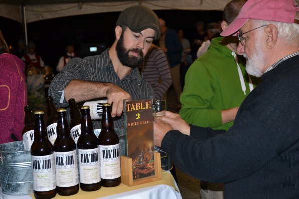 John Bergeron of White Birch Brewing pours a  glass of Hop Session for Joseph Kayal of Huntington, N.Y. Kayal used two hands on his glass to ensure he did not lose a drop of the delicious craft brew.