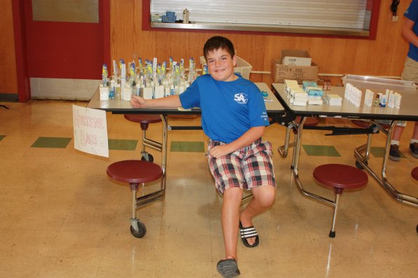 Brady Haywood-Minery, 12, mans the hygiene pack table.