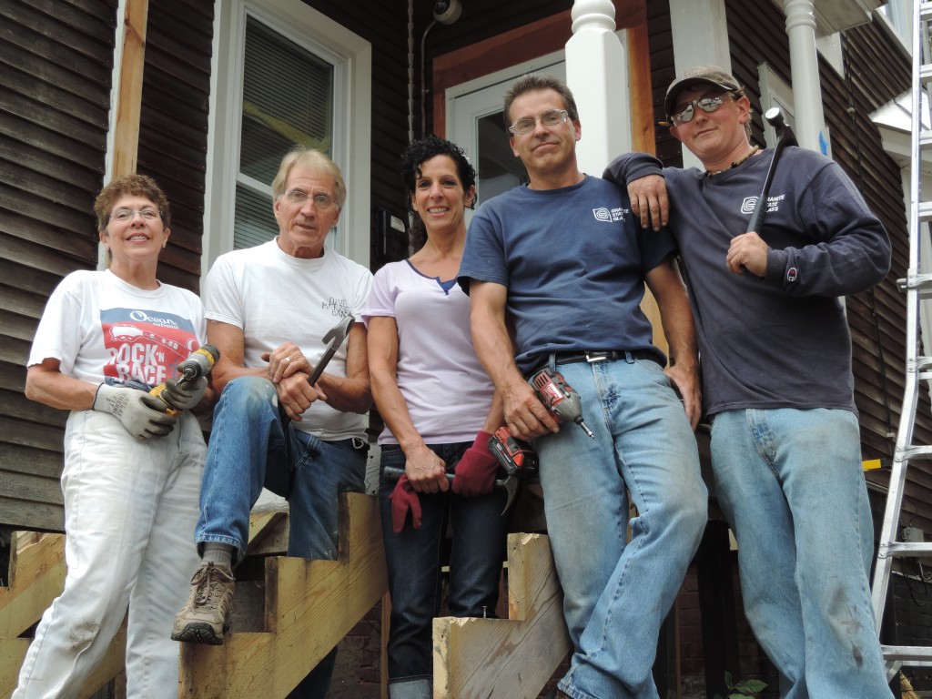 What has three hammers, two drills and only one visible foot? An industrious monopod? Actually, no, it’s these people! This is Linda Bliss, Steve Christensen and Jennifer Stacy, all from Rotary Club of Concord, along with Art Michaud and Pete Crateau from Granite State Glass. The Rotary Club continues to invest time, talent and treasure in Child and Family Services’ transitional living home on Perley Street. Over the years, the Rotary has dedicated itself to the CFS Transitional Living Program, which provides housing, life skills training and supportive services to formerly homeless youth as they work toward becoming self-sufficient, independent adults. During these final weeks of summer, a team from Rotary spends Wednesdays refurbishing the house, making major repairs and improvements. The project is being coordinated by Mike Stacy of the Rotary Club, with donations of material and labor from Granite State Glass, and supplies from Big Jim’s, with the help of Don Steenbeke, Jr. For more information on the CFS Transitional Living Program, visit, cfsnh.org.