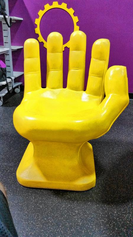 Clue: Sometimes when you squeeze in a vigorous workout, you just have to sit in a giant yellow hand chair. Because that’s not weird, right? Answer: Keith is one of those people who actually likes to work out. Weird, we know. And when he needs to work up a sweat it’s at Planet Fitness. - 
