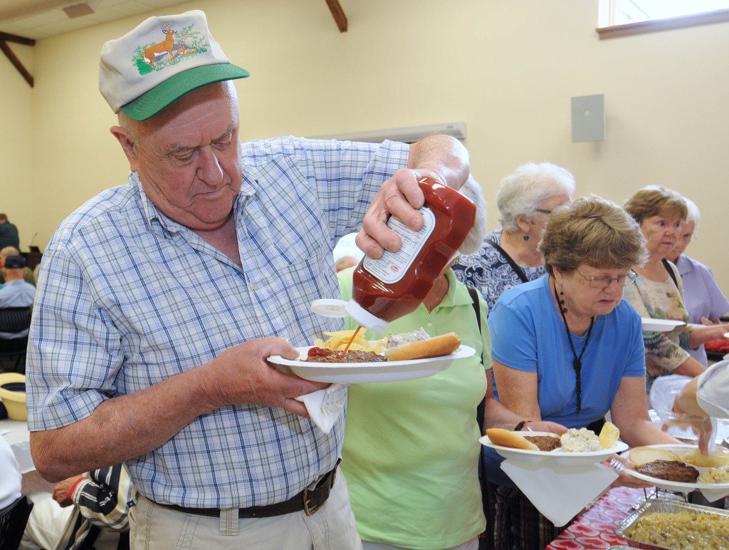 Dave Casic knows how to dress a burger! He was at the new Centennial Senior Center barbecue social last week, which was held in partnership with the Penacook Community Center Senior Program.