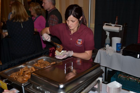 Mackenzie Dalrymple serves up a sausage slider that earned Arnie’s Place the No. 1 spot in the annual Top Slider contest.