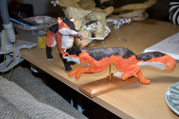 A couple of clay foxes.