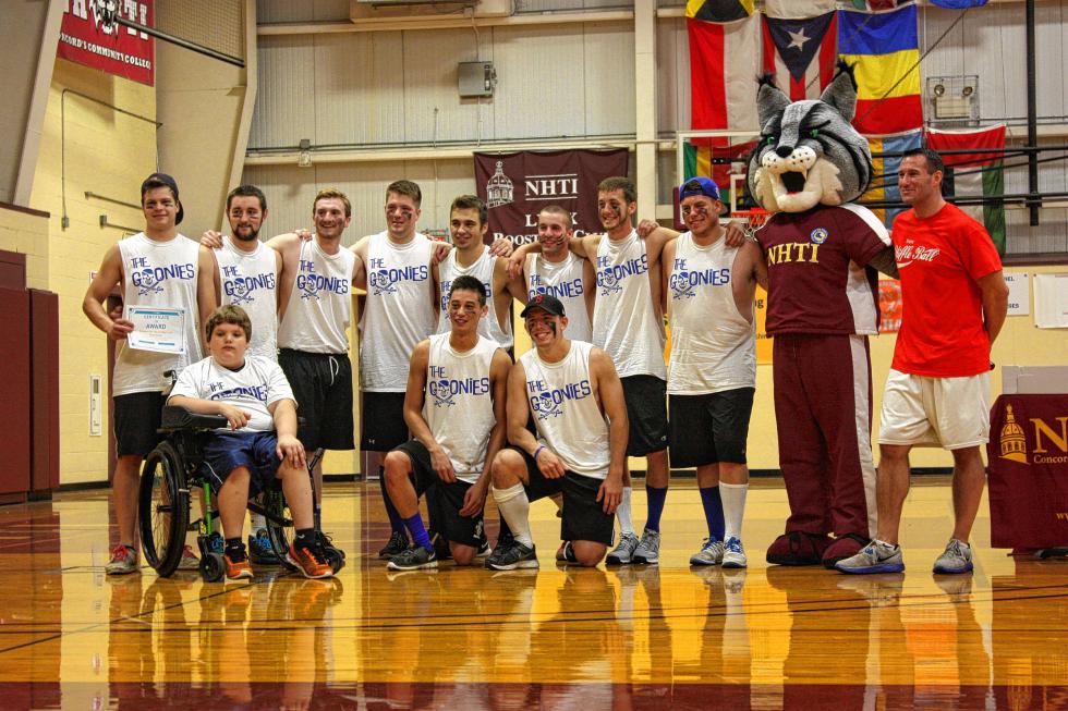 The Goonies, who led all teams in fundraising (and also dominated the Monitor/Insider team), pose for a photo with Seth. (JON BODELL / Insider staff) - 

