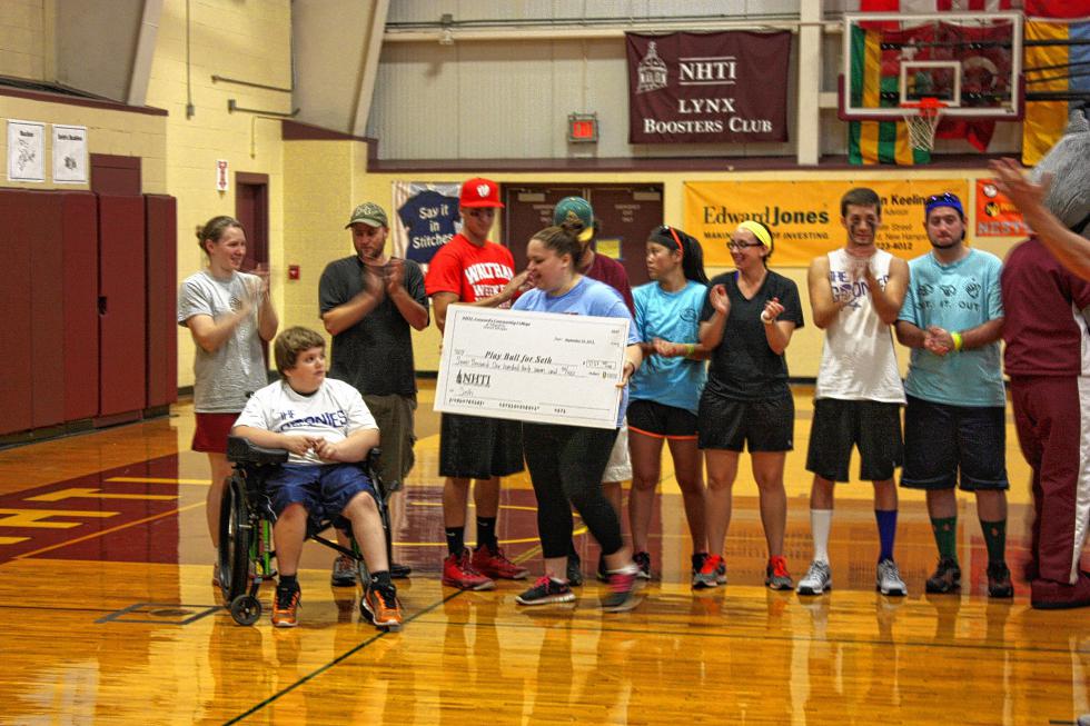 Seath Peake, 10, is presented a check for more than $7,100 at NHTI's Play Ball for Seth Wiffle Ball Tournament at NHTI on Sunday. Peake was diagnosed with hemophilia before he was born, and the Wiffle Ball tournament was a charity event to help with his medical costs. (JON BODELL / Insider staff) - 
