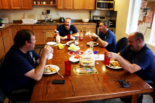 Firefighters sit down for a meal with their second family at Manor Station.