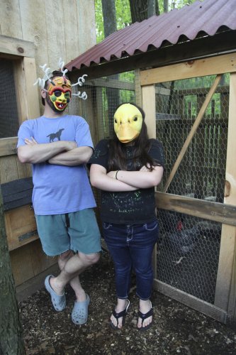 "Clucky" and his daughter "Eggy" stand in front of their backyard chicken coop. They are raising the birds without the minimum one acre of land required by the city.