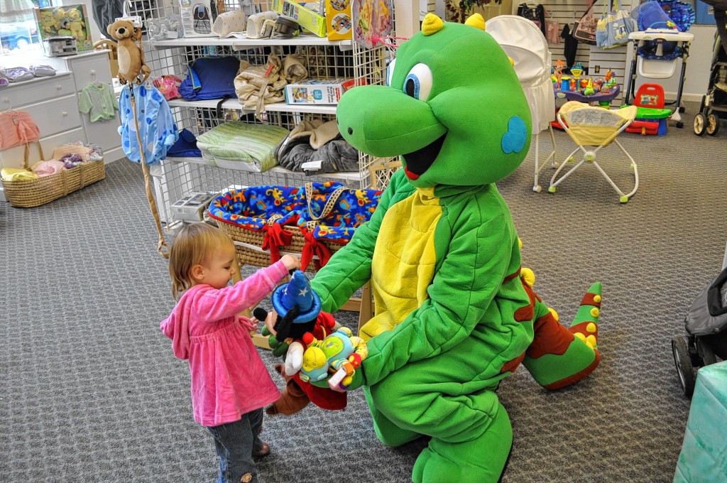 Lil’ Iguana of Lil’ Iguana’s Children’s Safety Foundation made a stop at Here We Grow Again on Sept. 5, and ran into 18-month-old Aurora Doane, who already has a firm grasp on the concept of sharing. She illustrated that fact by bringing a handful of toys to the Lil’ Iguana, one at a time. Good looking out, Aurora!