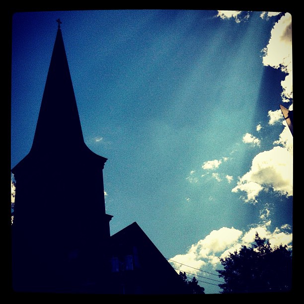 Here’s a cool Instagram pic from @corinnejanelle. It’s a silhouetted steeple with beaming sun rays – can anyone guess the location?