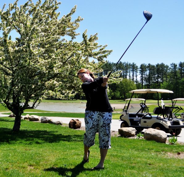 Golf pro Julie Donlon takes a swing at Beaver Meadow Golf Course.