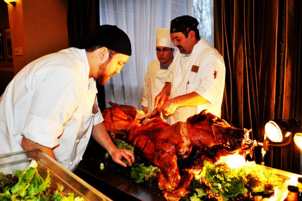 Thayne Clough, executive sous chef at the Marriott, carves up some pork.