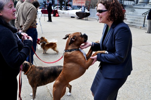 Former Concord Monitor reporter (and current Maggie Hassan policy adviser) Molly Connors (right) gets a friendly greeting from Daisy, who was with Marylee Gorham of the New Hampshire Humane Society.