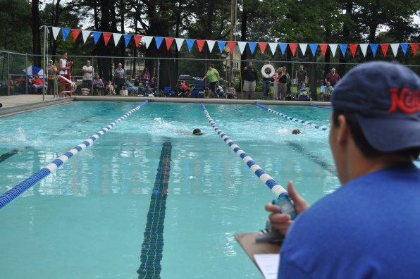 Ian Wagner keeps close watch on the times during a heat at the city swim meet Aug. 2. Six of the city’s pools were represented by five teams (Keach and Merill joined forces) for an Olympic-worthy morning.